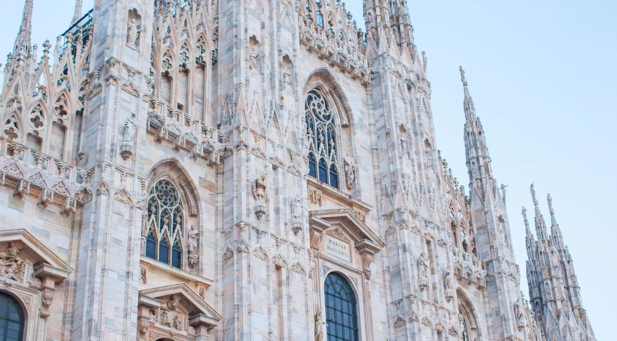 Close marble facade details and windows on the Duomo di Milano